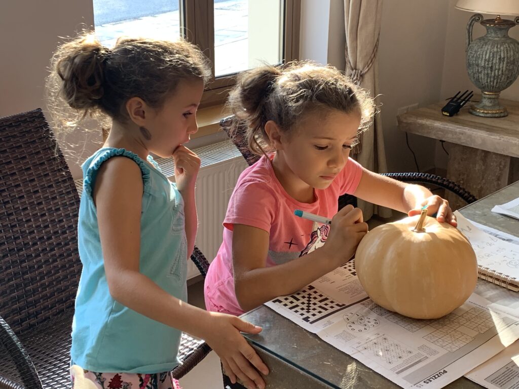 Drawing the Merkitty design on the front of our pumpkin.